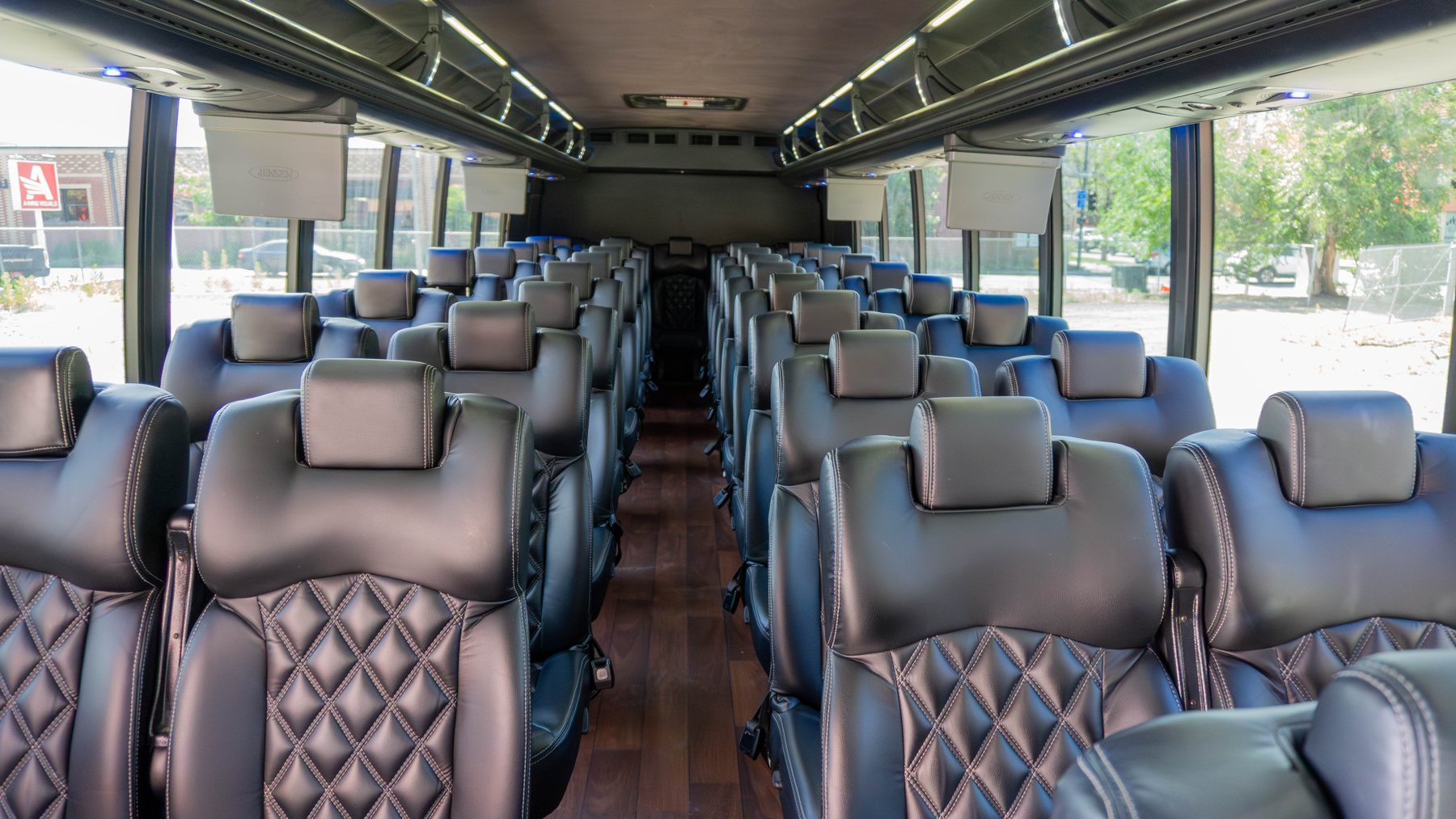 Rows of upholstered seats inside the executive coach